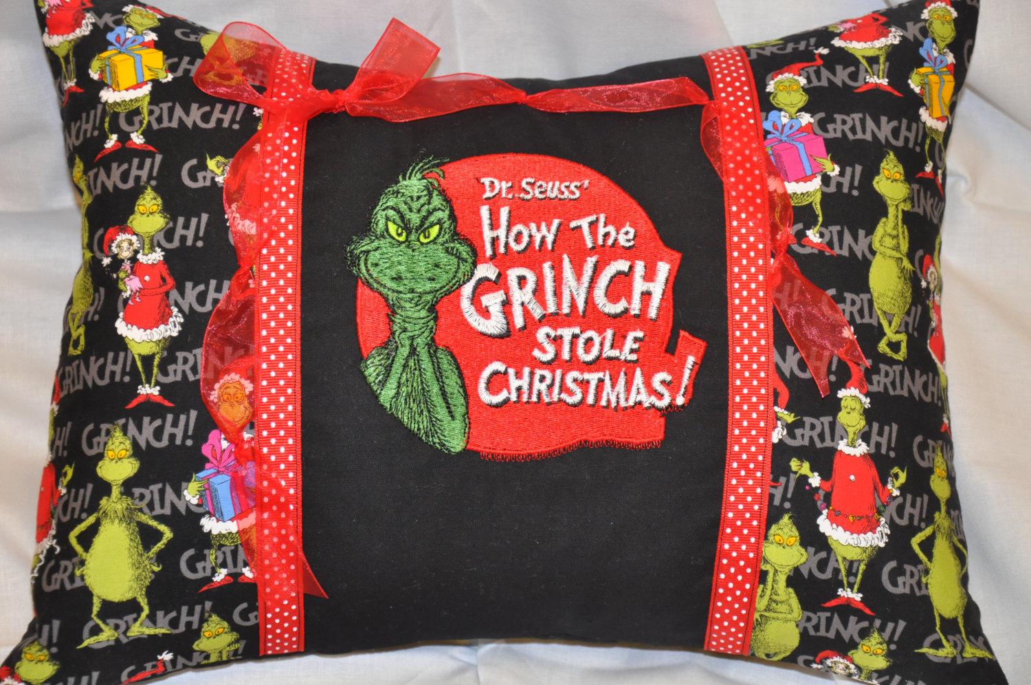 A pillow with Grinch embroidery design