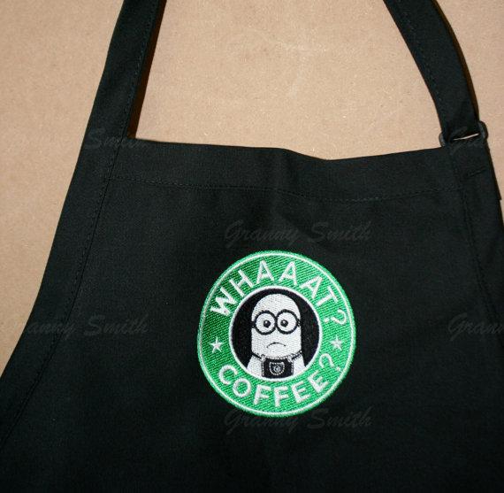 A black apron with a Whaat? Coffee? minion embroidery design