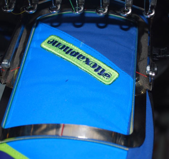 how sew embroidery logotype on winter wear Embroidery process final stage