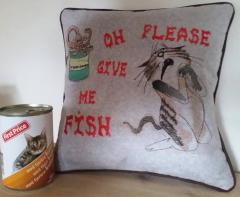 Sofa cushion with sneaky cat free machine embroidery design