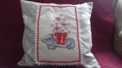 Embroidered cushion with cross stitch design