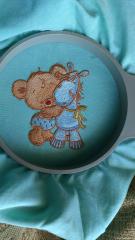 Finished teddy and pony embroidered design in round hoop