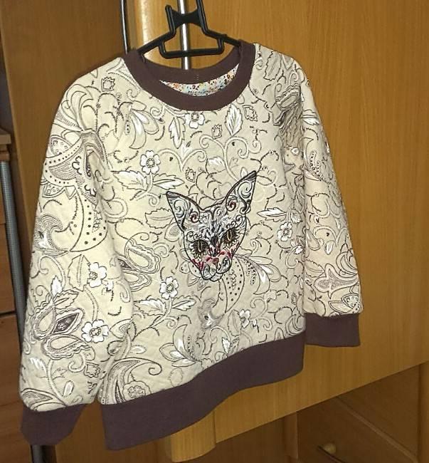 Embroidered cat design on clothing