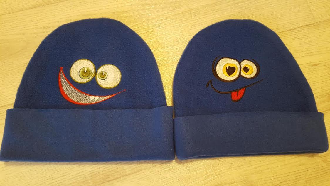 Two embroidered caps with faces free designs