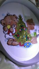 Embroidered bear decorating christmas tree design