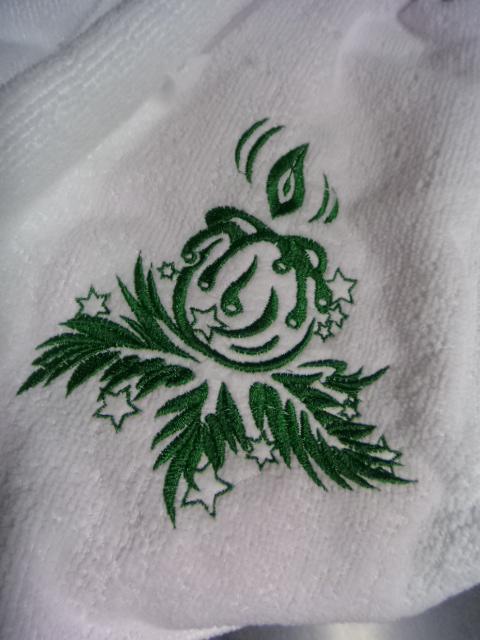 A towel with a Christmas candle free embroidery design