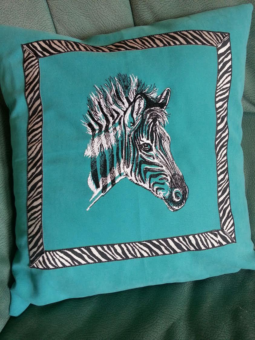 Embroidered pillow with head of zebra design