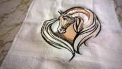 Embroidered towel with horse heart design