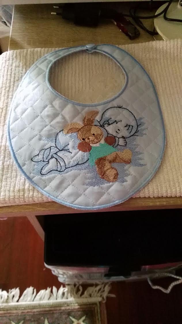 Embroidered bib with boy and toy design