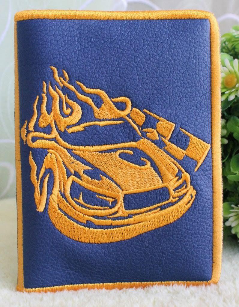 Embroidered book cover with racing car design