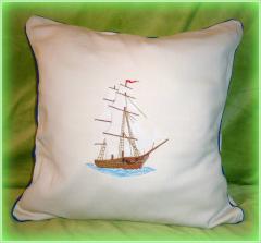 Decorative pillow with sailboat machine embroidery design