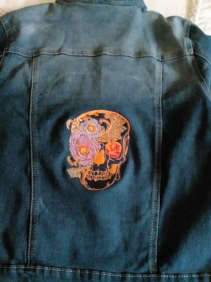 Fragment of embroidered jacket with flower skull design