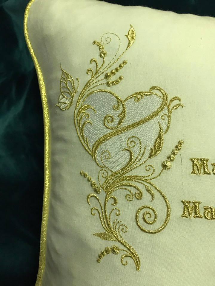 Embroidered cushion with golden heart design