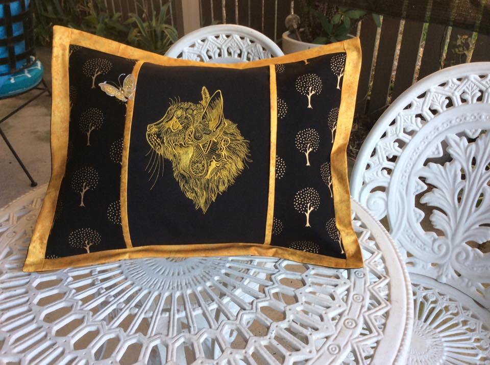 Embroidered pillow with fancy cat design