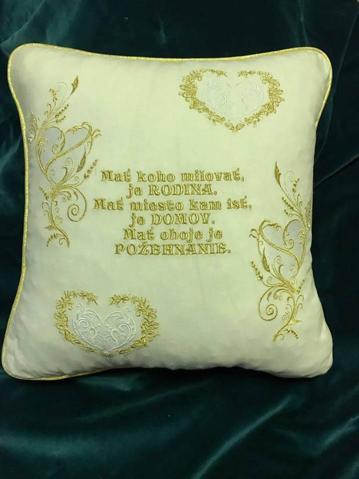 Embroidered white cushion with golden heart design