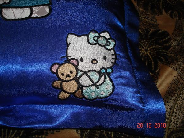 A pillow with Hello Kitty and Tippy the Bear: detail