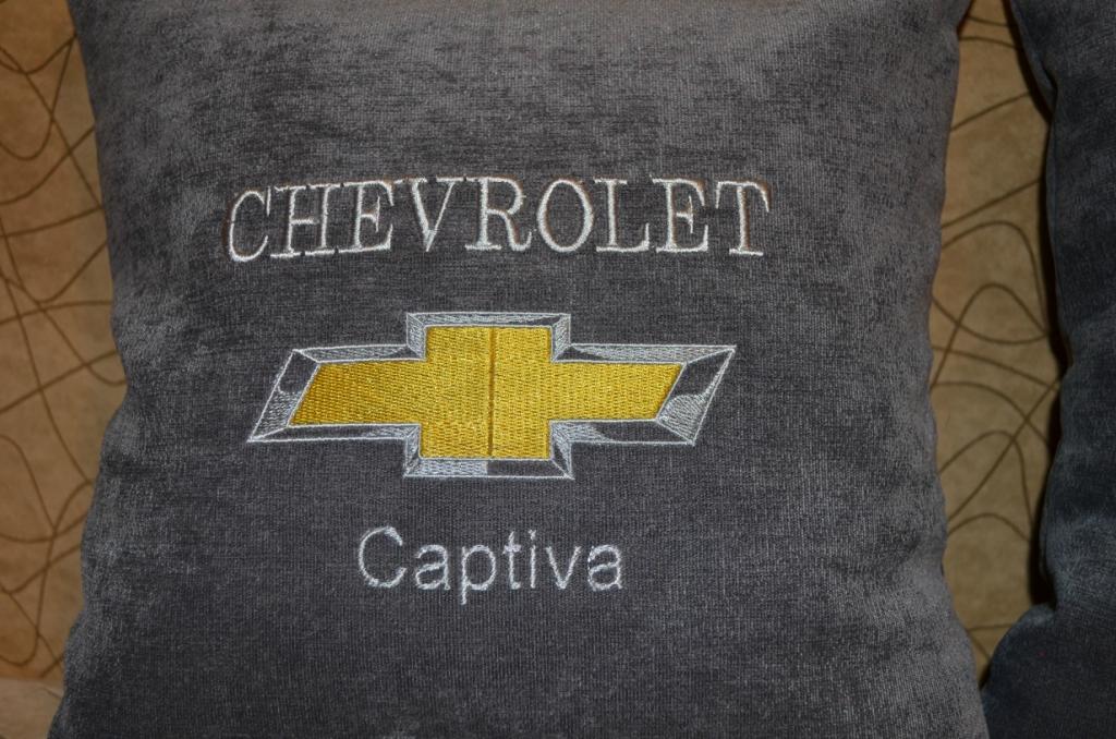 A pillow with an embroidered Chevrolet Captiva logo on it  (detail)