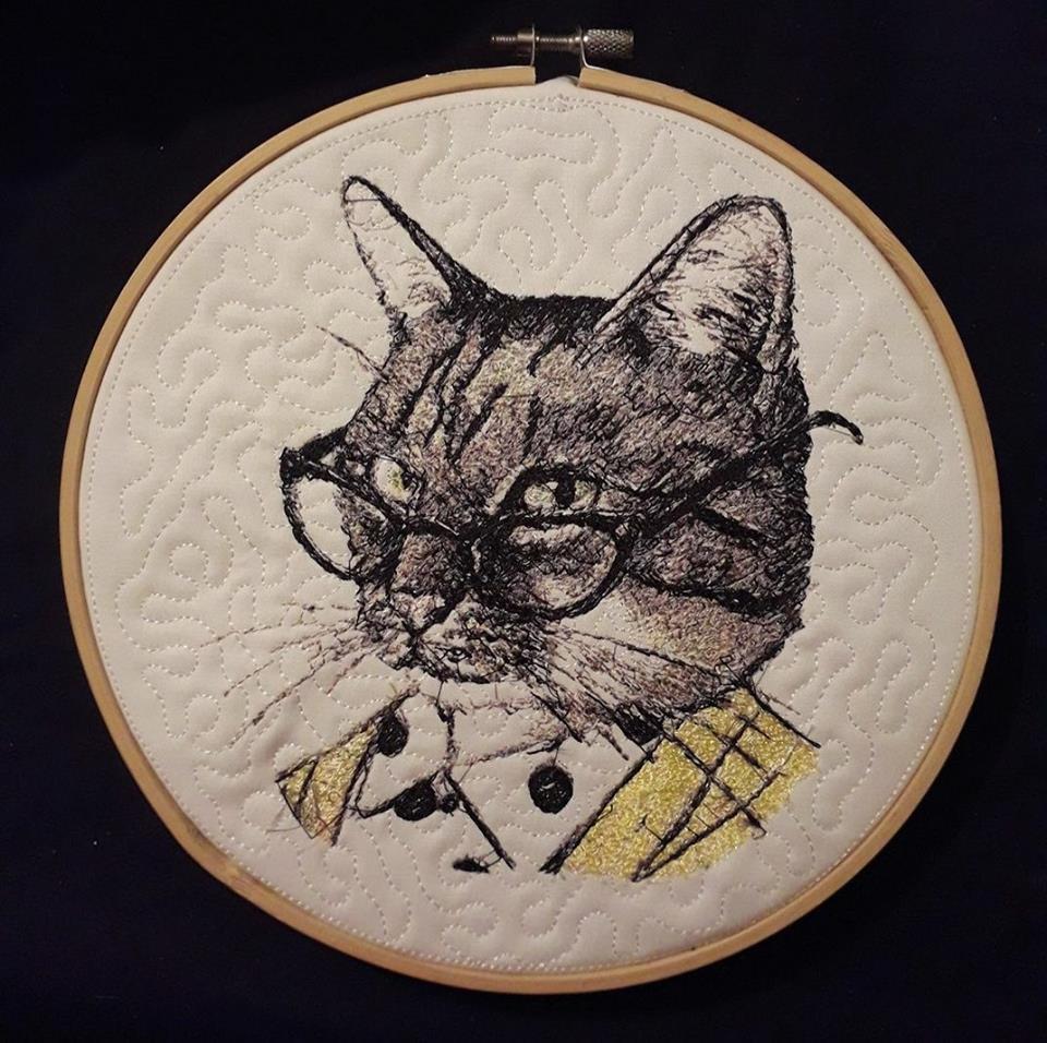 Embroidered cat in a stylish wooden hoop
