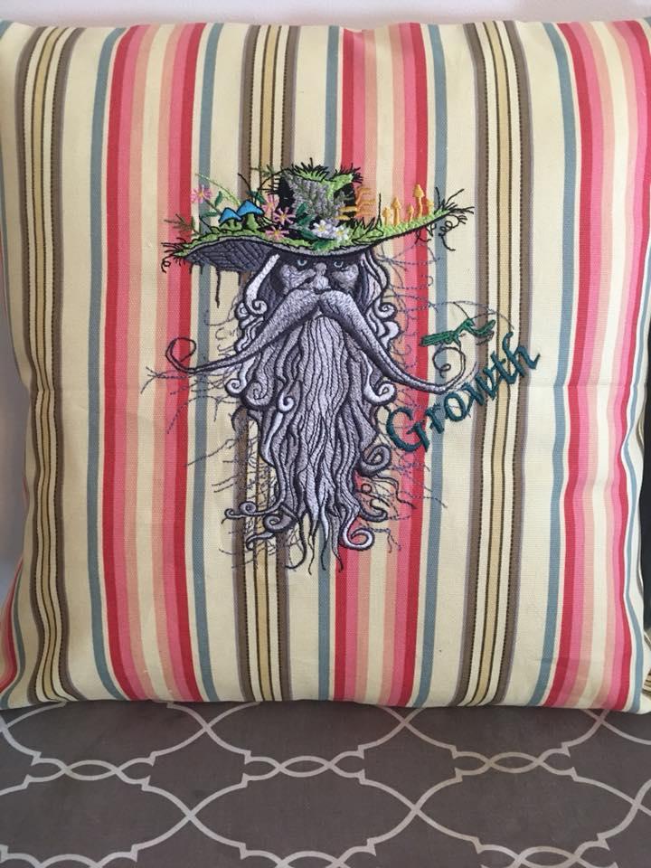 Embroidered cushion with root man design