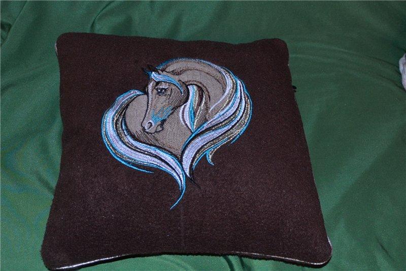Pillow with a sad horse machine embroidery design