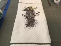 Embroidered towel with Root man design