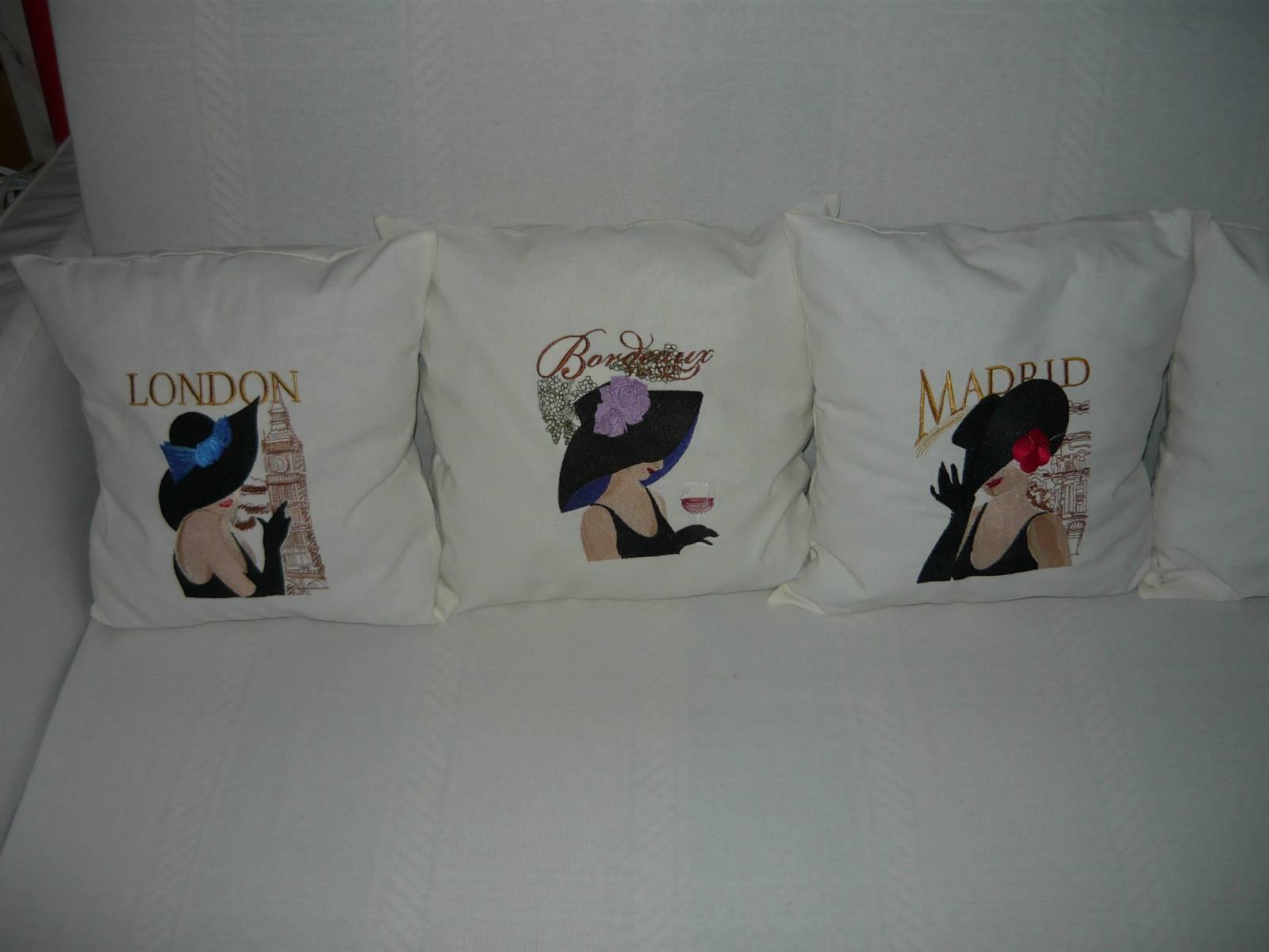 A set of white pillows with ladies from different capitals