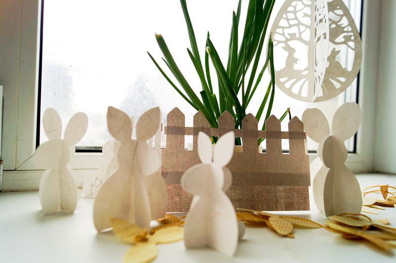 Easter bunnies with the egg decoration closer look Paper bunnies and fabric fence