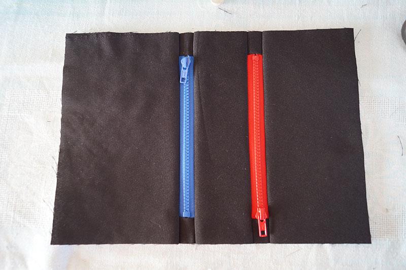 Zippers ready Red and blue zippers on black fabric