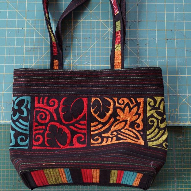 Black bag with red, yellow, green and blue embroidery