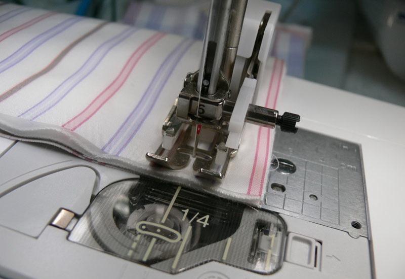 Seam allowance Layers of striped fabric under presser foot