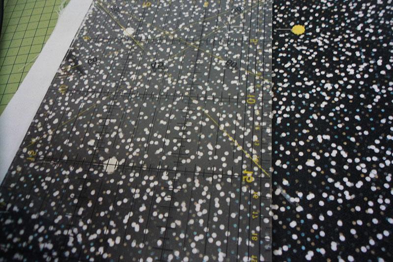 Drawing diagonal lines Ruler on black fabric