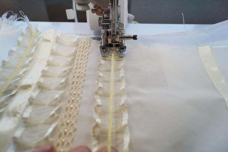 Attaching ruffles to sleeves White ribbons stitched to sleeves