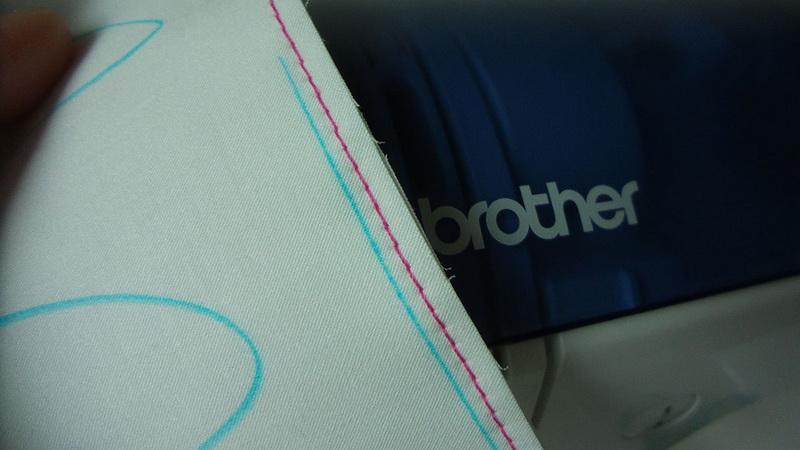 The resulting joining stitchline Row of pink straight stitched alonside blue line