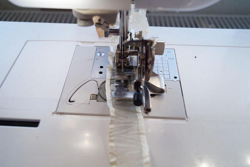 Pushing ribbon into the foot White ribbon put through Ruffler foot