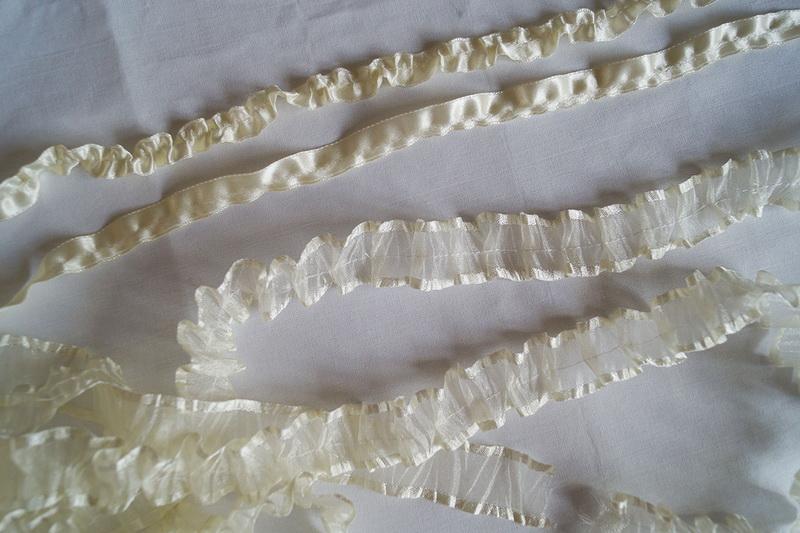 Many different ribbons Various white ruffled ribbons