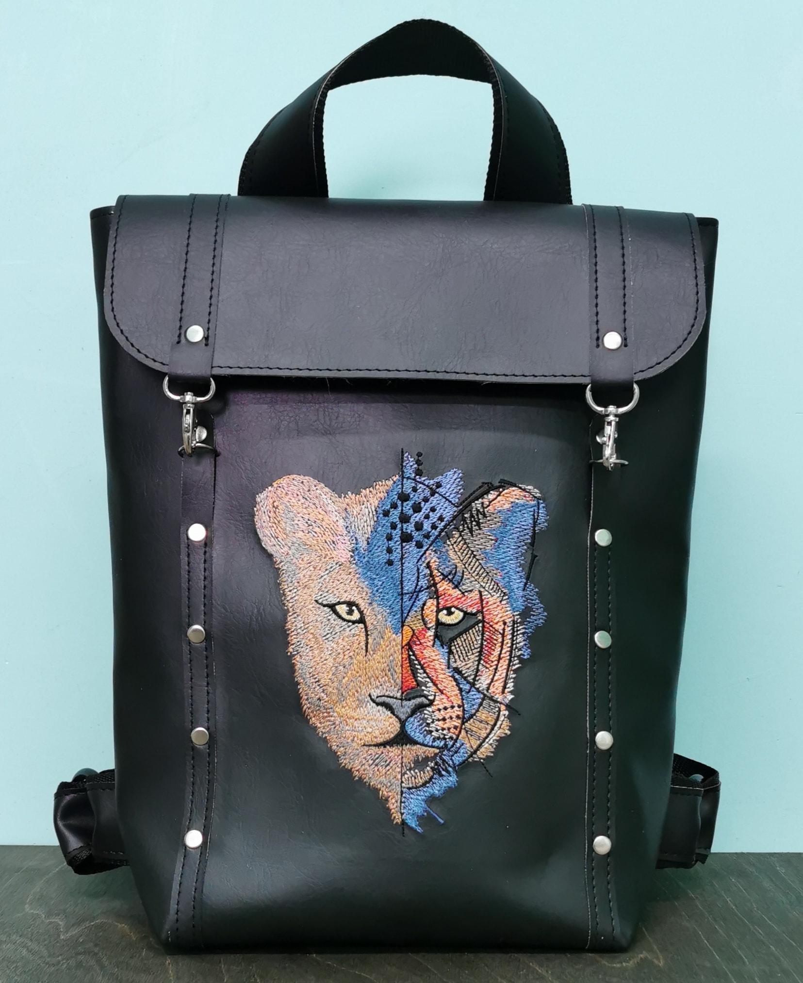 Embroidered leather backpack with Unreal lion design