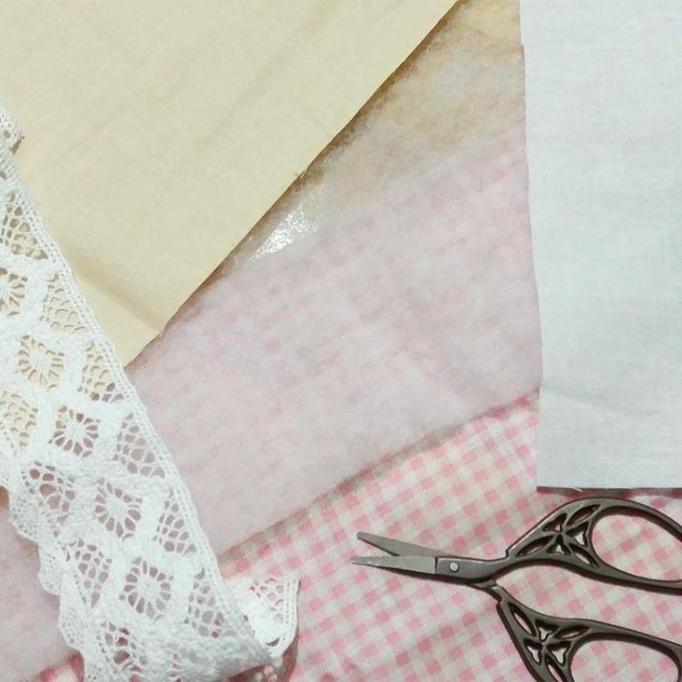 Fabric, lace and scissors Materials and tools for making a pot holder