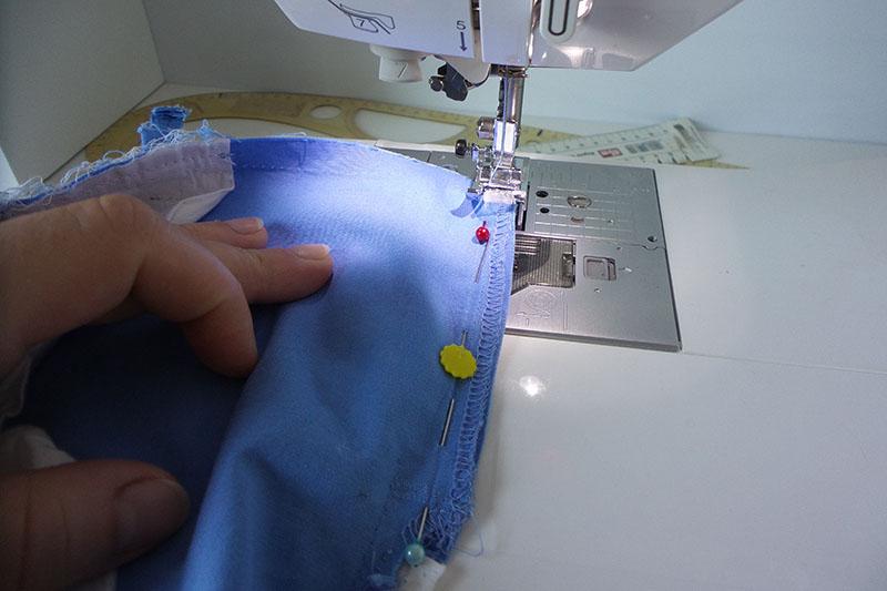 Zipper is being stitched to shorts