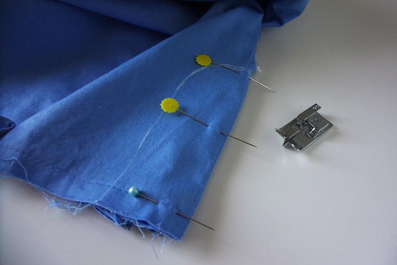 Edge of blue shorts with pins