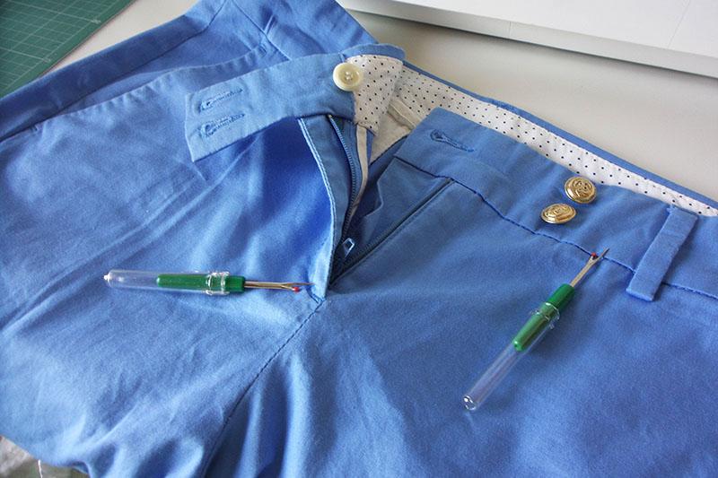 Seam ripper on blue shorts