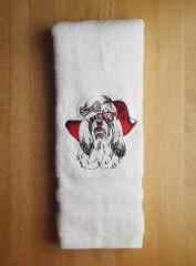 Towel with embroidered maltese dog design